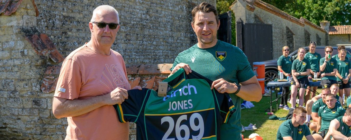 Tim Jones is presented with a Saints shirt by Phil Dowson.