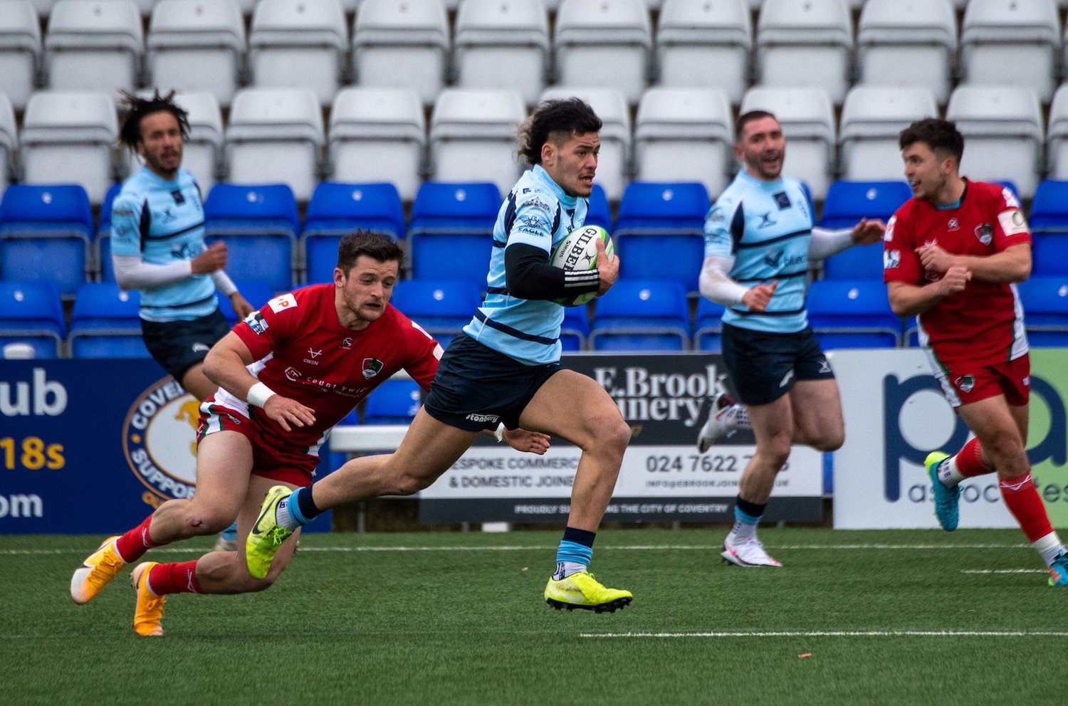 Connor Tupai from Northampton Saints breaks through for Bedford Blues