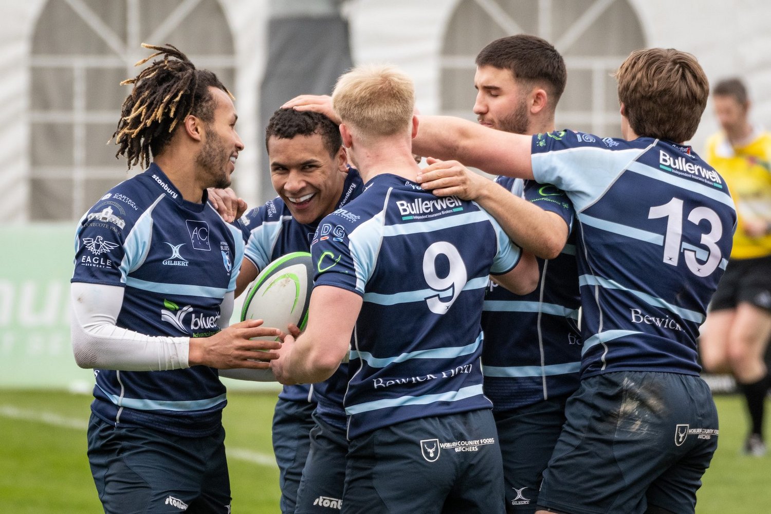 Bedford Blues celebrate Saints' Ryan Olowofela's try