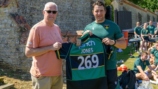 Tim Jones is presented with a Saints shirt by Phil Dowson.